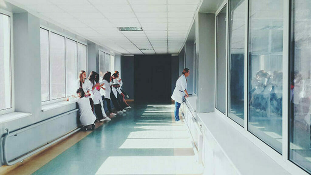 Healthcare Cleaning Services: Content hospital staff in a bright corridor.