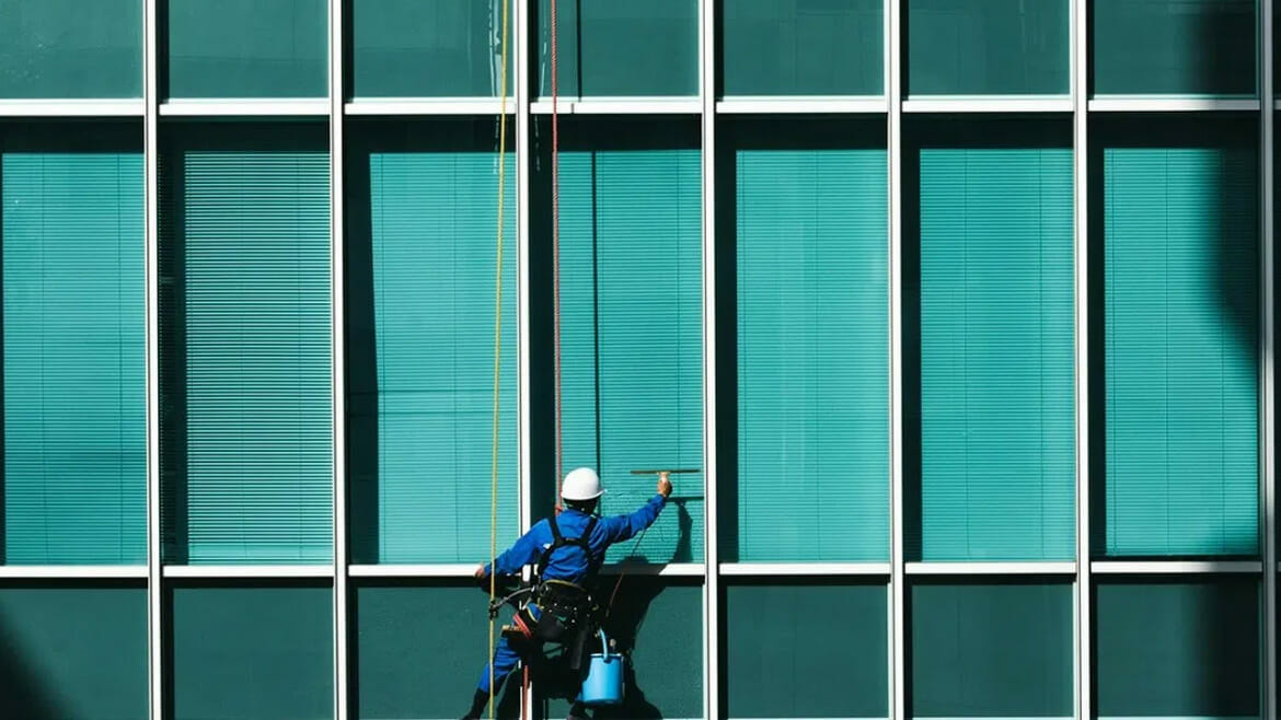 Commercial Cleaning in Denver: Skilled Worker Cleaning Building Windows