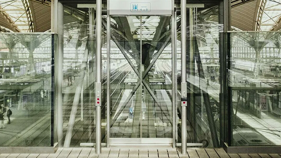 Commercial Cleaning in Denver: Glass Elevator with Train Station in the Background