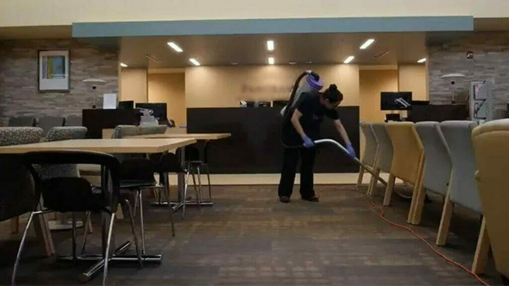 Commercial Office Cleaning: Woman Vacuuming Clinic Reception Area