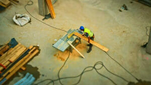 Construction Cleanup: Top-Down View of Construction Worker Using Circular Saw
