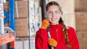 Industrial Cleaning: Young Woman with Cleaning Equipment in Warehouse