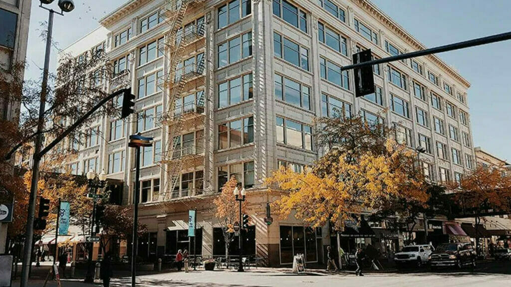 Office Cleaning Tips for Fall in Denver: Corner Building Amidst Autumn