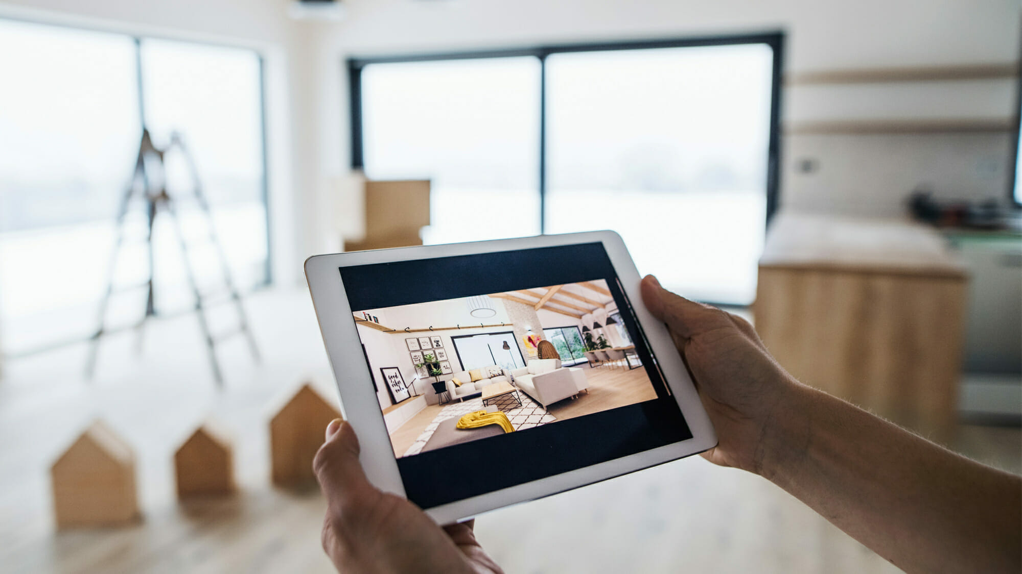 Person with iPad displaying a virtual tour of the construction site.