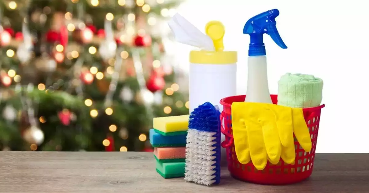 Christmas tree in the background with a section of a sofa and cleaning products in the foreground.