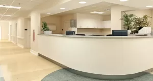 Spacious medical office reception area with clean countertops, computer monitors, and a large potted plant, maintained by 3Aclean in Denver, Colorado.
